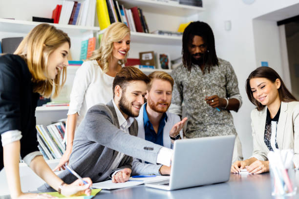 istock Colleagues brainstorming in office while pointing out new ideas on laptop 663269118