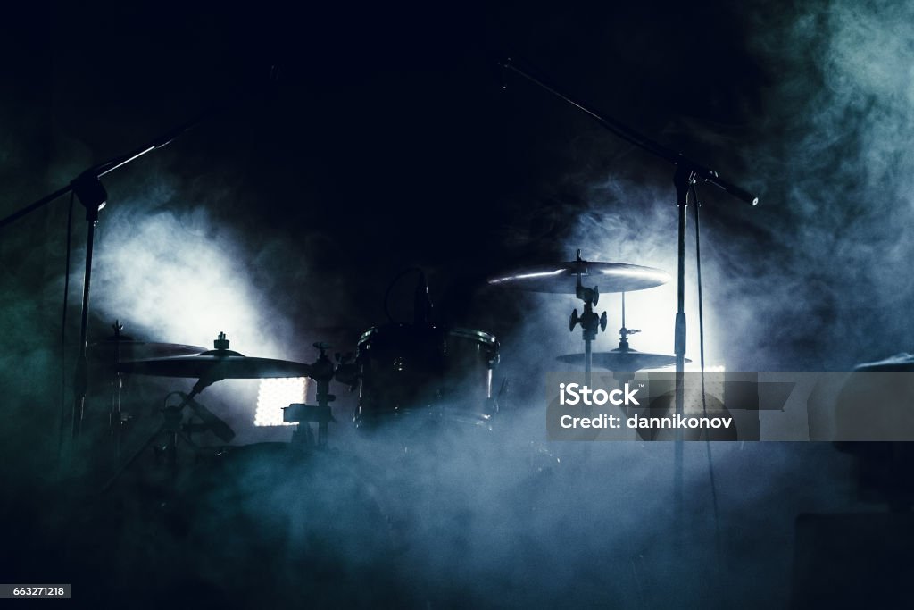 Drum set in smoke on a stage cymbals set and drums in smoke and light of searchlights Rock Music Stock Photo