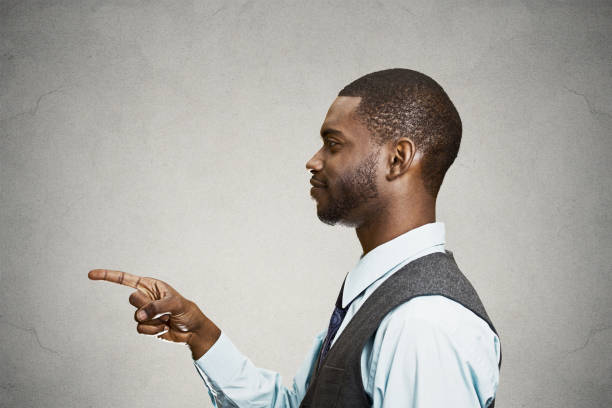 istock young man, pointing with finger at someone, something 663279088