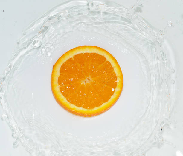 istock orange in water on white background 663282280