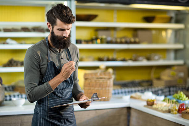 istock Salesman holding clipboard at counter 663286786