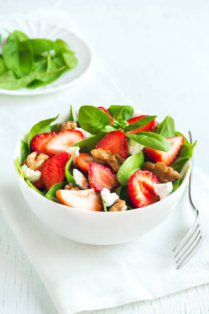 Strawberry and spinach salad Strawberry and spinach salad with feta cheese and walnuts, organic heathy diet vegetarian salad food. vinegar stock pictures, royalty-free photos & images