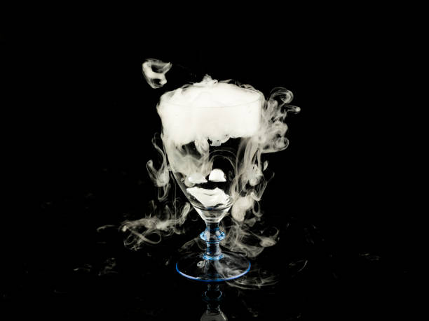 istock hot water in wine glass with smoke on black background 663300590