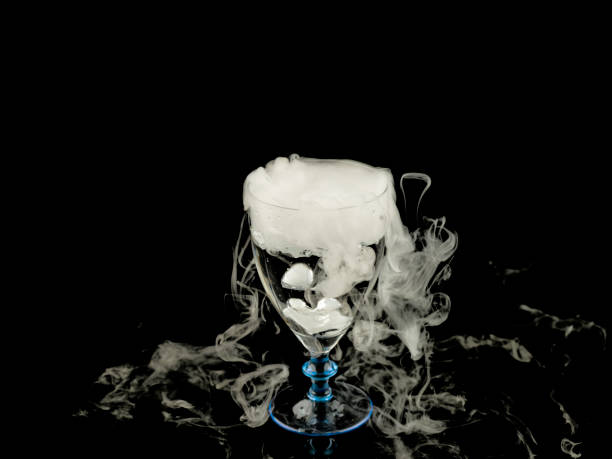 istock hot water in wine glass with smoke on black background 663300606