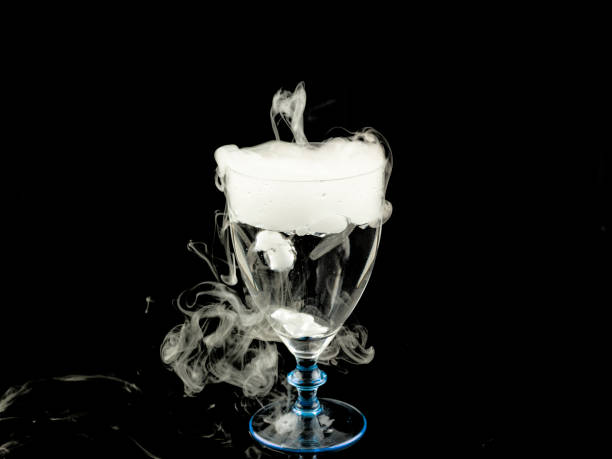 istock hot water in wine glass with smoke on black background 663301660