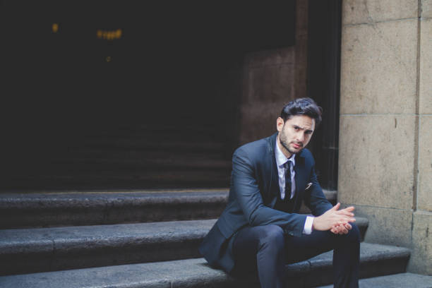 istock Businessman sitting on the stairs 663312184