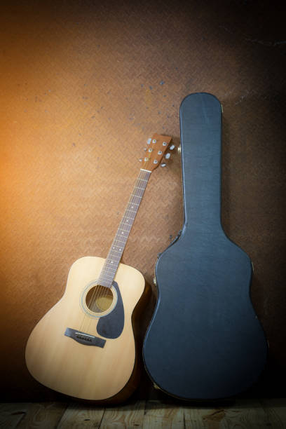 istock acoustic guitar with hard case on old steel background 663322840