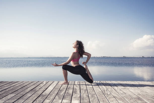 istock Young woman doing yoga exercises 663325920