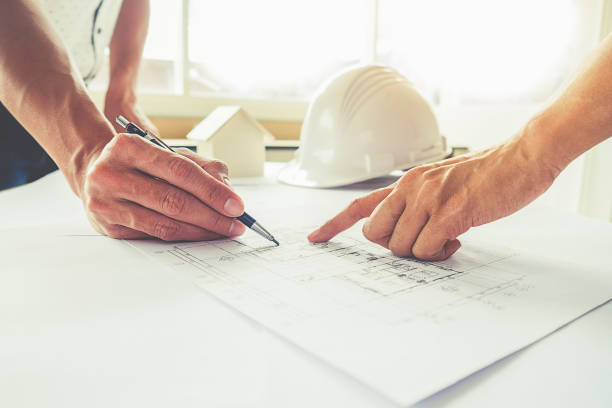 istock Hands of Engineer working on blueprint,Construction concept. Engineering tools.Vintage tone retro filter effect,soft focus(selective focus) 663325996