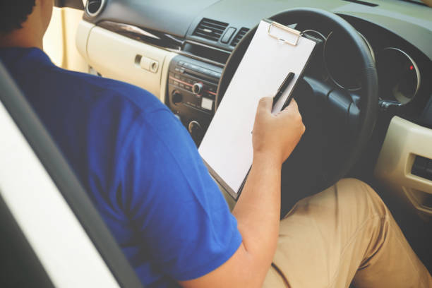 istock Delivery driver driving van with parcels on seat outside warehouse 663329370