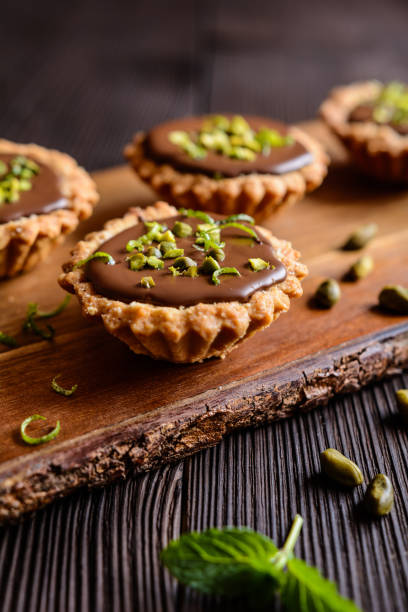 istock Tartlets with chocolate, pistachios and lime peel 663333236