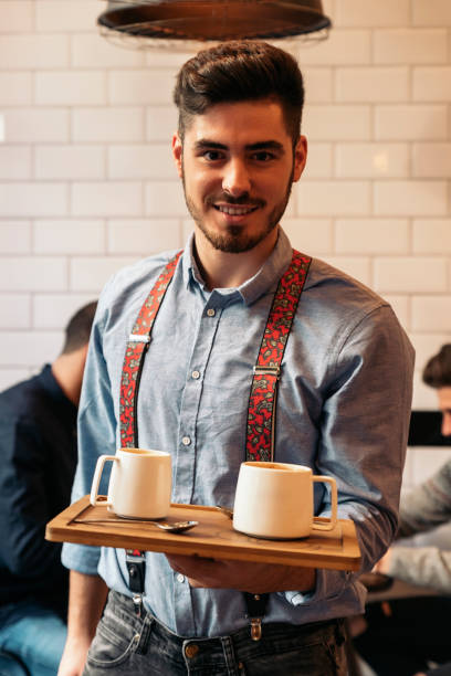 istock Waiter holding a tray with coffees. 663353108