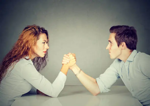 Business people woman and man arm wrestling