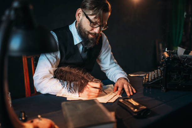 istock Bearded journalistr in glasses writes with feather 663370822