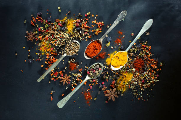 istock Spoons with spices seasoning on chalk black board 663373706