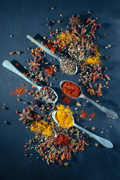 istock Various seasoning spoons on black chalk stone table. 663374042