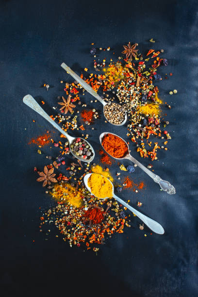 istock Various seasoning spoons on black chalk stone table. 663374354