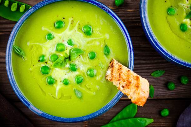 istock Green pea soup on wooden rustic background 663381852