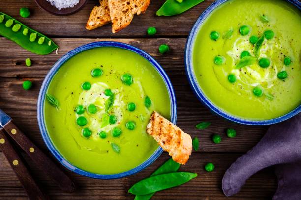 istock Green pea soup on wooden rustic background 663382014