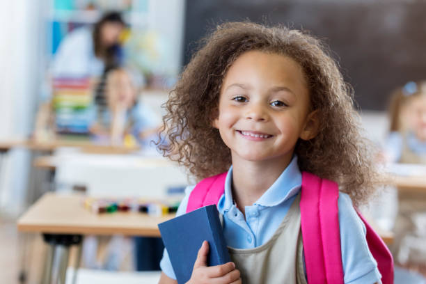 istock Pretty mixed race girl in preschool classroom 663389888