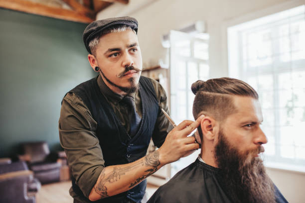 istock Bearded man getting haircut by barber 663393492