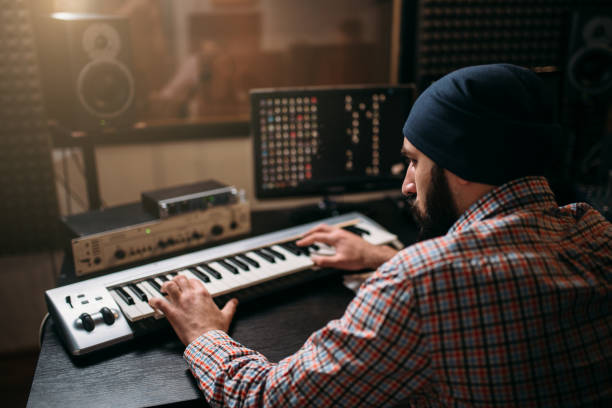 istock Sound producer work with audio equipment in studio 663398392