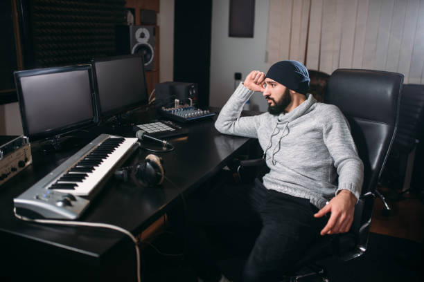 istock Sound producer with microphone in music studio 663404614