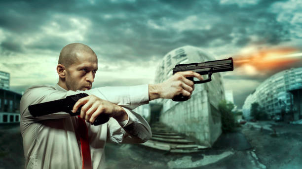 istock Serious killer shoot a pistols with two hands 663420272