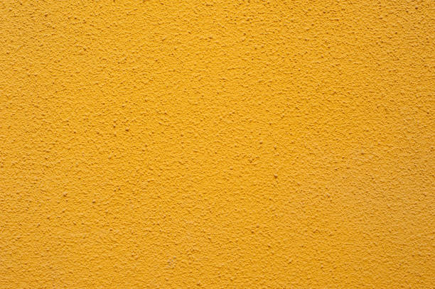 istock Texture of a textured yellow wall 663423010