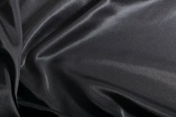 Photo of Fashion elegant dark fabric, black textile background.