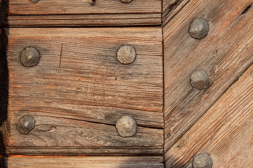 Old wooden boards with nails. Place for text. The wooden door of the castle
