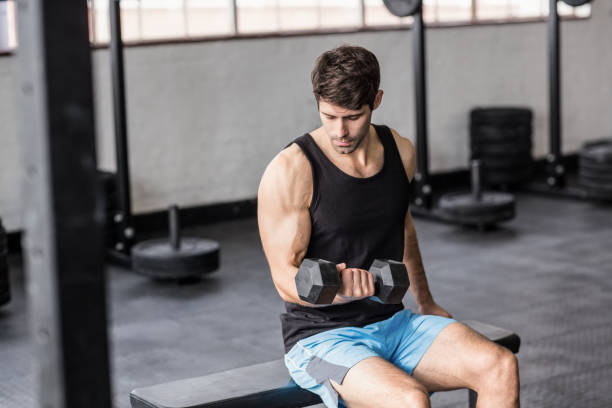 istock Sporty man exercising with dumbbells 663442278