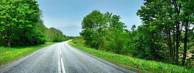 Panoramic view of a road with Adirondacks Mountains in the background