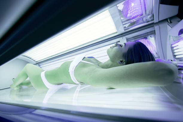 istock Beautiful woman lying in solarium and sunbathing 663461466