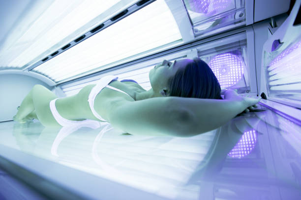 istock Beautiful sexy  brunette sunbathing in solarium 663461548
