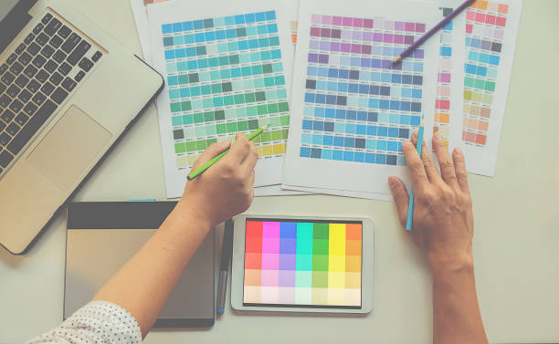 istock Graphic design and color swatches and pens on a desk. Architectural drawing with work tools and accessories. 663463930