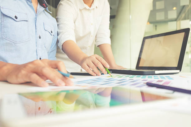 istock Graphic design and color swatches and pens on a desk. Architectural drawing with work tools and accessories. 663463938