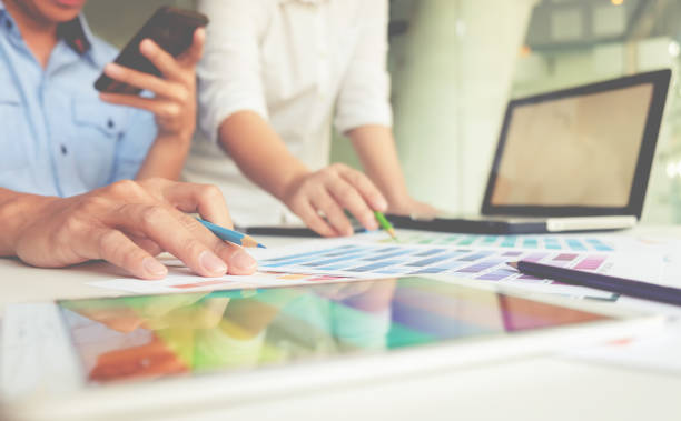 istock Graphic design and color swatches and pens on a desk. Architectural drawing with work tools and accessories. 663463940