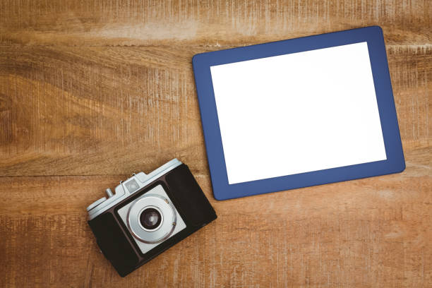 istock View of an old camera and a blue tablet 663471864