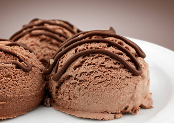istock brown ice cream scoops with chocolate sauce, macro 663494890