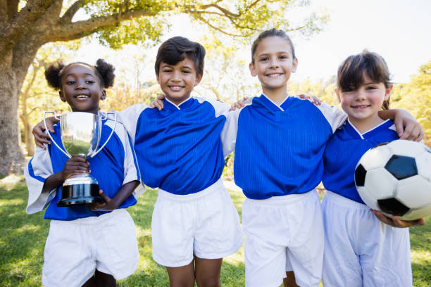 istock Children soccer team in raw smiling 663505104