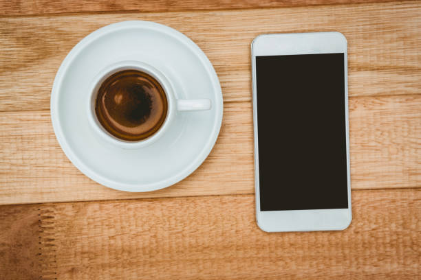 istock Above view of a coffee and a smartphone 663514400