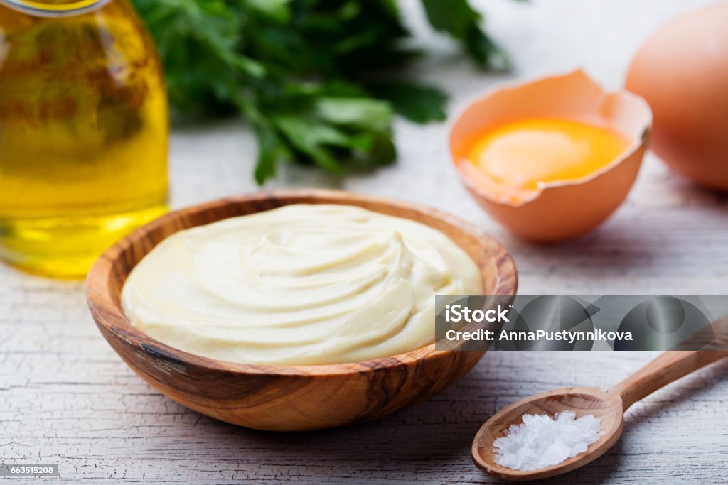 Homemade mayonnaise, mayo in a wooden bowl. White background Homemade mayonnaise, mayo in a wooden bowl. White background. Mayonnaise Stock Photo