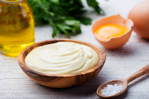 Homemade mayonnaise, mayo in a wooden bowl. White background Homemade mayonnaise, mayo in a wooden bowl. White background. mayonnaise photos stock pictures, royalty-free photos & images