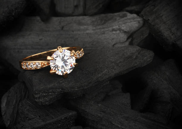 jewelry ring witht big diamond on dark coal background