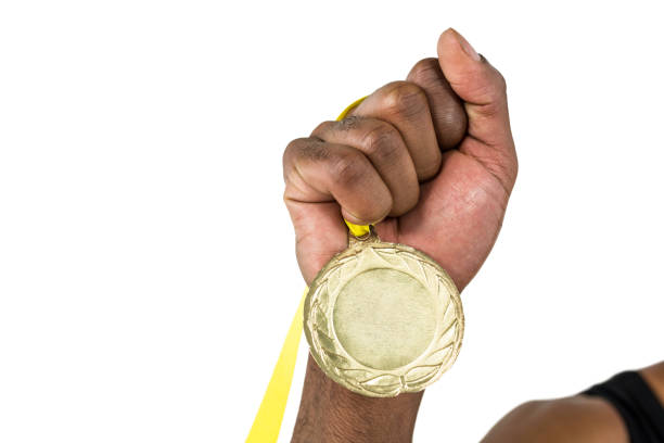 istock Athlete holding gold medal after victory 663542604