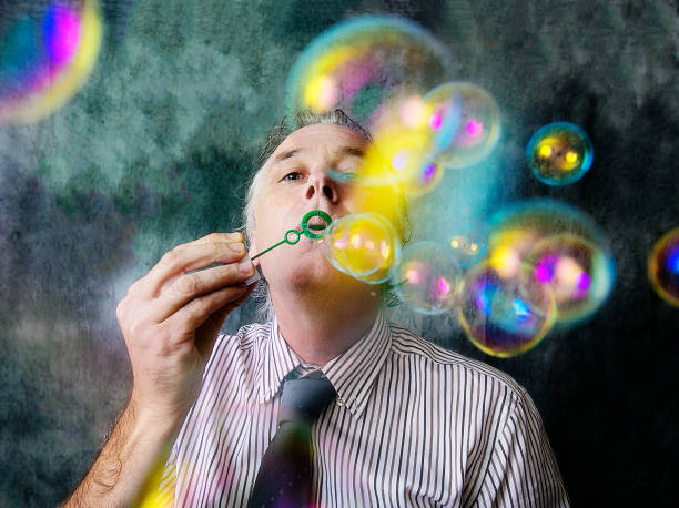 Young man playing with bubbles in the living room on a break from work.