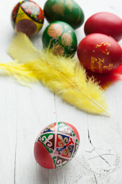 istock Easter eggs and white wooden country table, background and texture 663556784