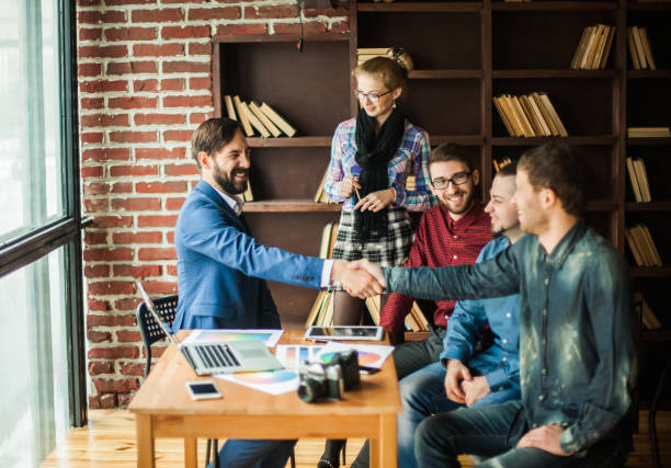 istock handshake business partners at a meeting in creative office 663577044