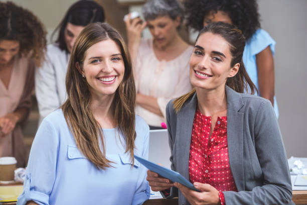 istock Portrait of two interior designers with digital tablet 663579272